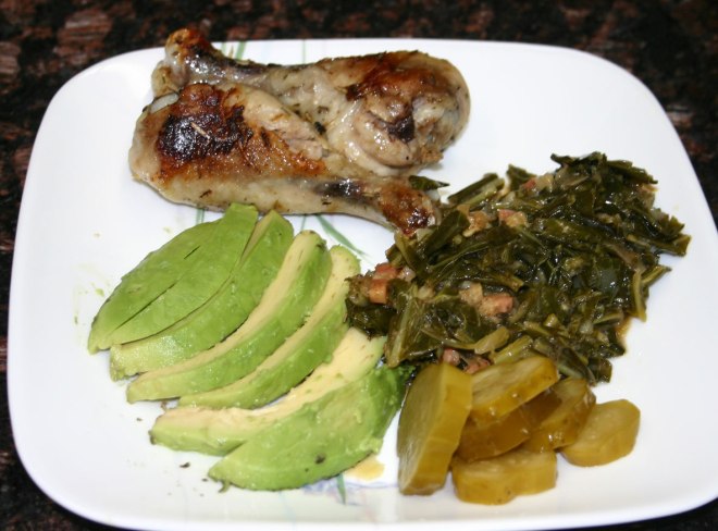 2 Chicken drumsticks, collard greens with bacon, half a sliced avocado and some pickles